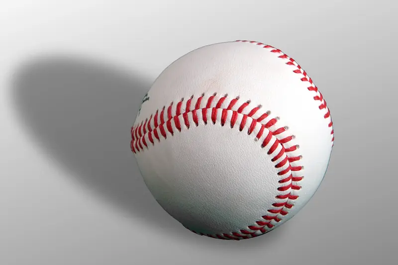 An official baseball with red stitching