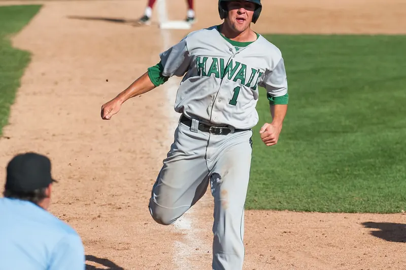 A runner crosses home plate to score a run